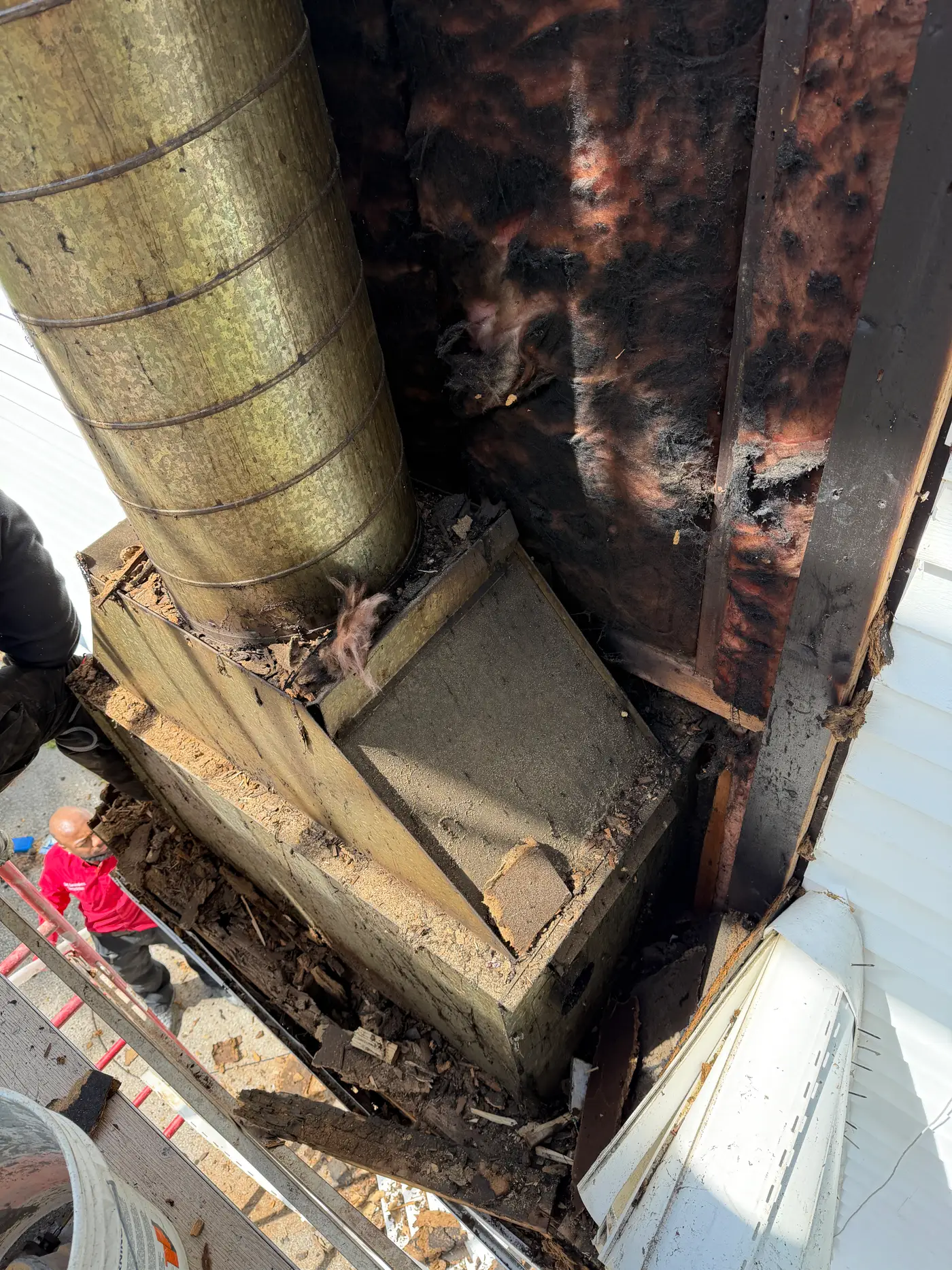 Chimney chase opened during removal of fire-damaged prefab chimney system — Crestwood, KY