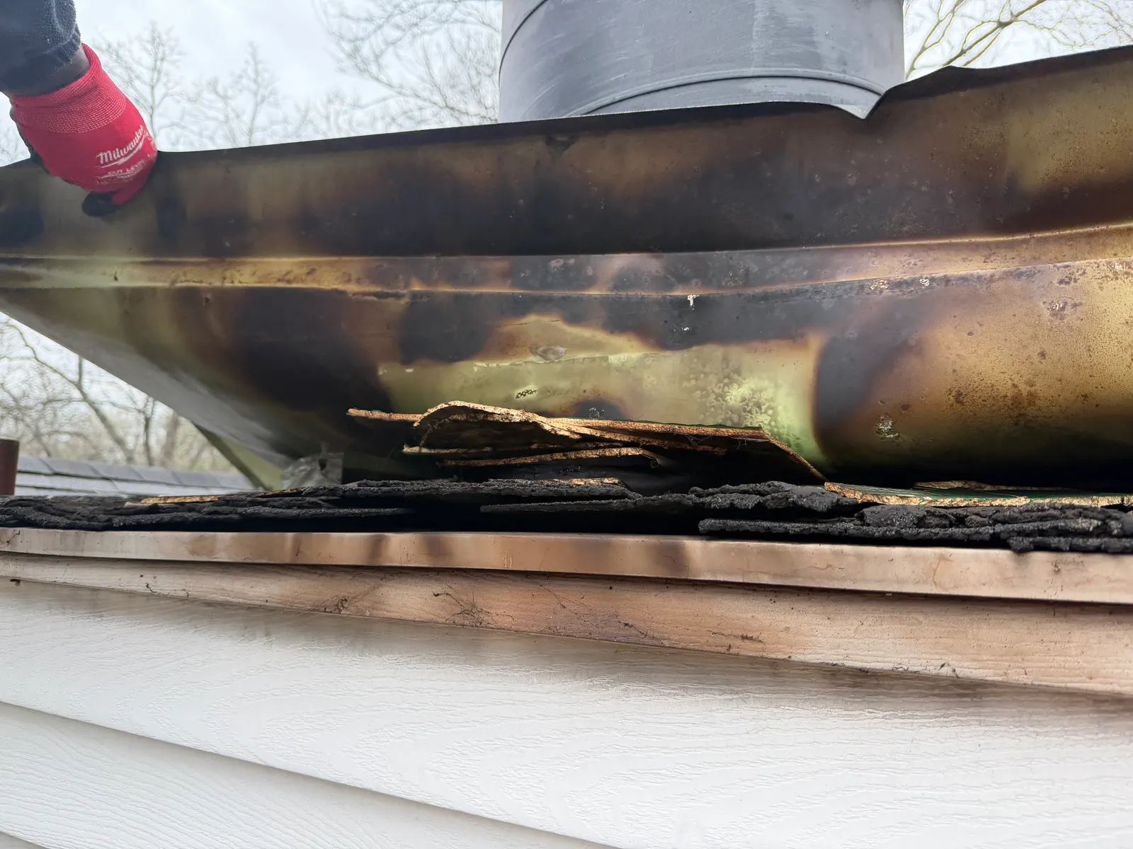 Scorched chase cover and charred sheathing from a hidden chimney fire — Crestwood, KY