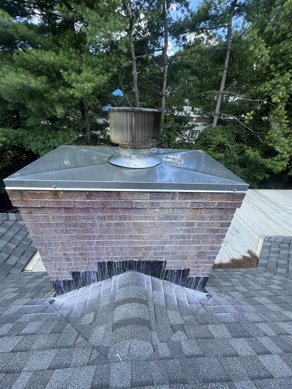 Finished stainless steel chase cover shedding water off its sloped top — Louisville, KY